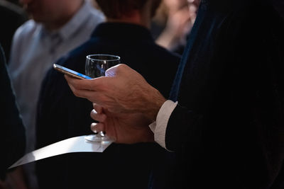 Midsection of man holding drink