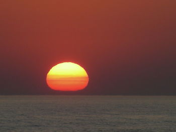 Scenic view of sea against orange sky