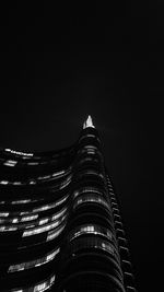 Low angle view of illuminated building against sky at night