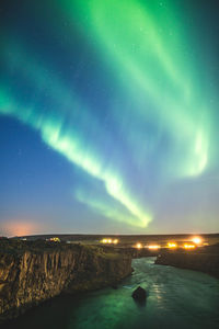 Scenic view of lake against sky at night