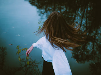 Rear view of woman standing in water