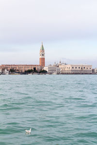 View of sea and buildings against sky