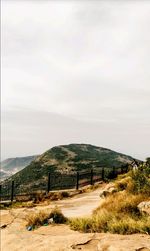 Scenic view of road by building against sky