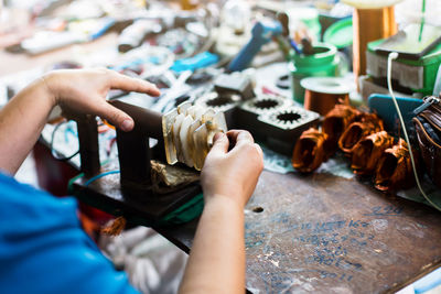 Midsection of man working on table