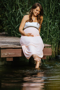 Full length of woman standing in lake