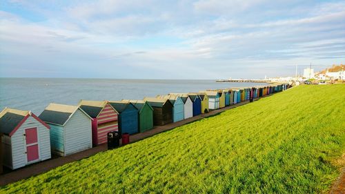 Beach huts in a row against calm sea