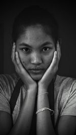 Close-up portrait of young woman at home