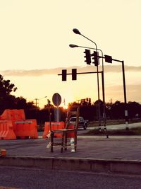 Street lights against sky during sunset