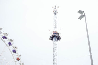 Low angle view of amusement park rides against clear sky