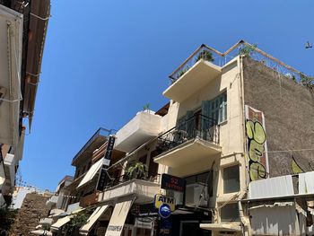 Low angle view of buildings against clear blue sky