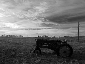 Abandoned tractor on field against sky