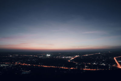 High angle view of illuminated buildings against sky at sunset