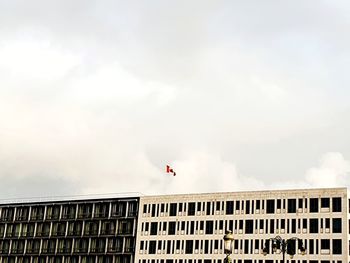 Low angle view of flag on building against sky