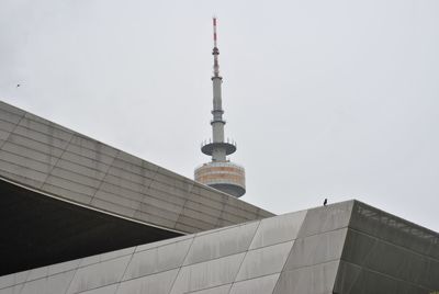 Low angle view of olympic tower against clear sky in city