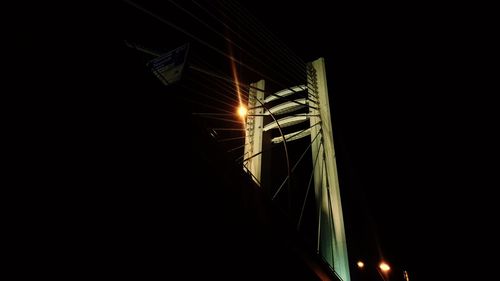 Low angle view of illuminated street light at night