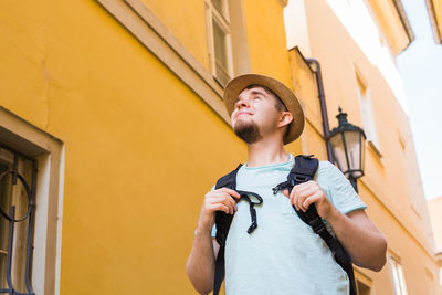 Low angle view of young man looking away