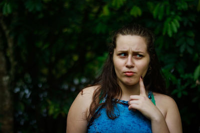 Thoughtful teenage girl standing outdoors