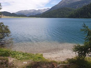 Scenic view of lake and mountains against sky