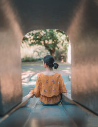 Rear view of couple sitting outdoors