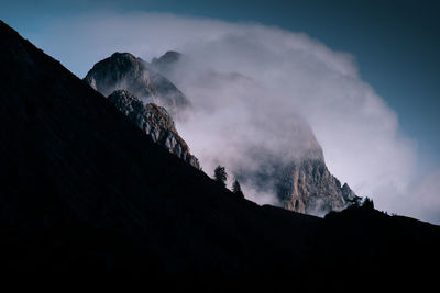 Cinematic view of fog on mountain peak dark and dramatic landscape