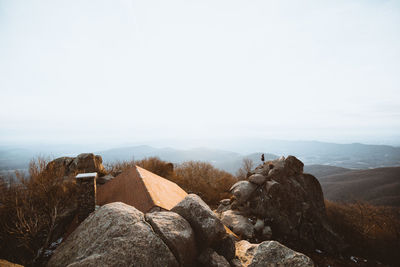 Rocks on mountain against clear sky