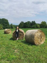 Hay bales on field against sky