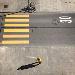 High angle view of man walking on footpath