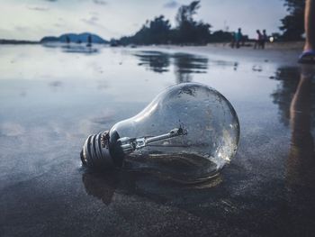 Close-up of light bulb on water