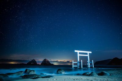 Scenic view of snow against sky at night