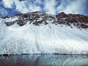Close-up of snow on mountain against sky