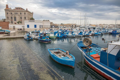 Boats moored at harbor