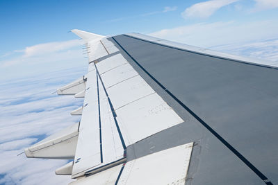 Low angle view of airplane flying against sky