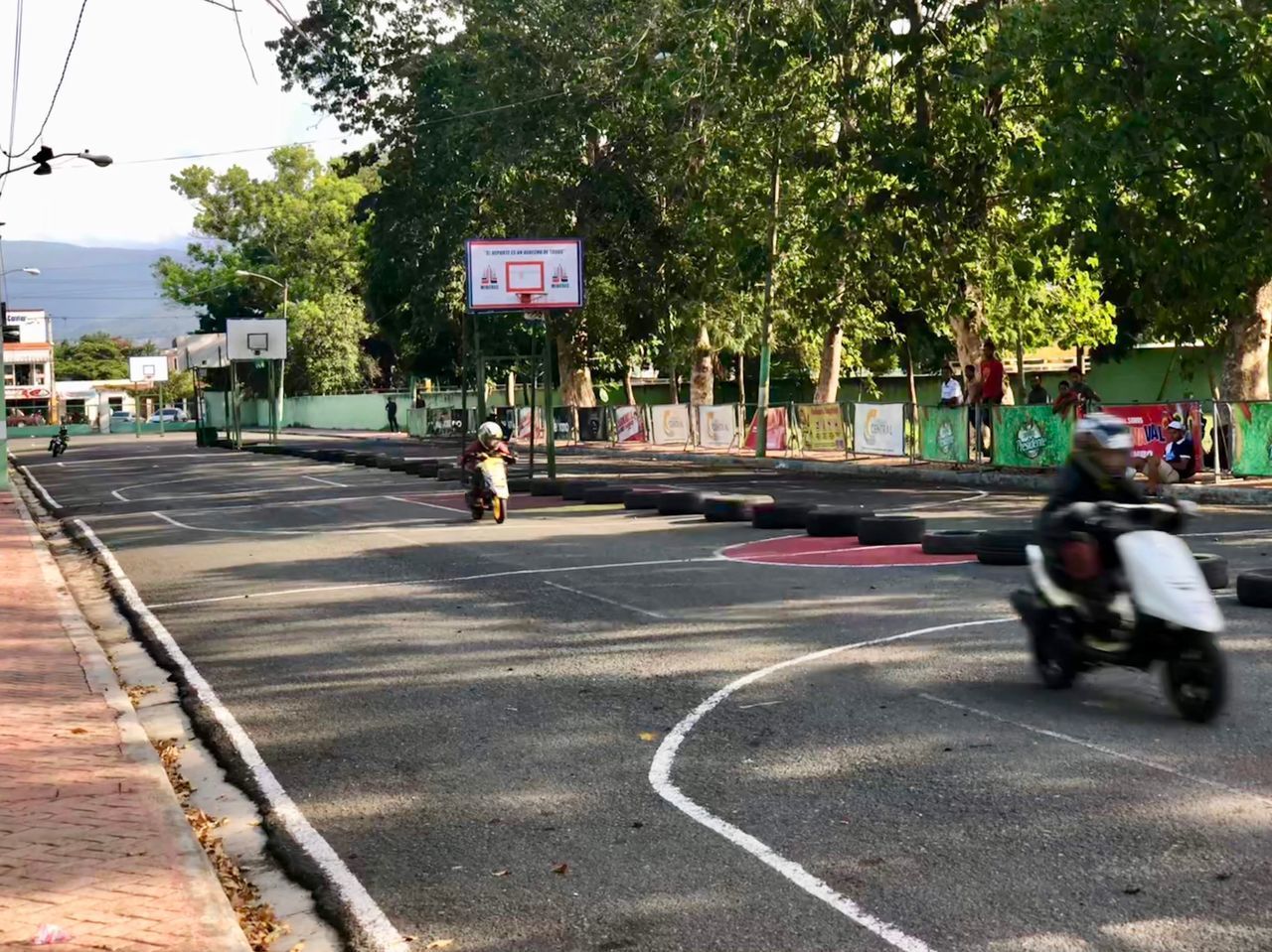 PEOPLE RIDING MOTORCYCLE ON ROAD IN CITY