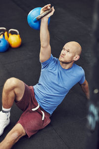 Man training in gym with kettlebell