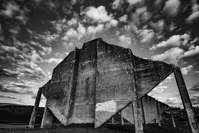 Low angle view of abandoned built structure against sky