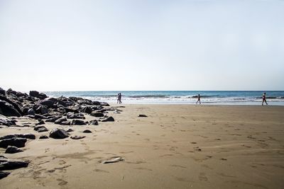 Scenic view of beach against clear sky