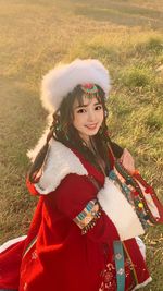 Portrait of young woman standing on field
