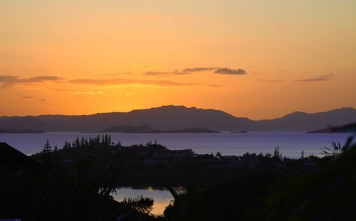 Scenic view of lake against romantic sky at sunset