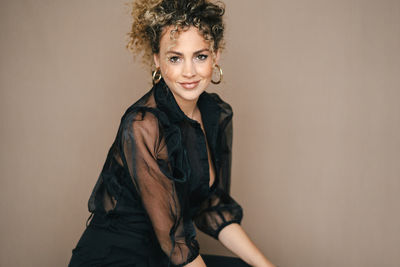 Portrait of a smiling young woman against white background