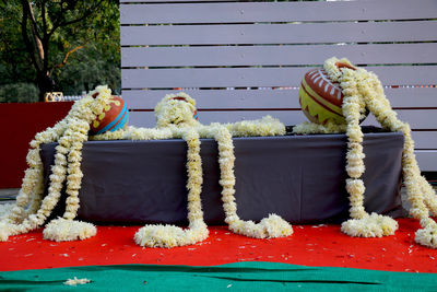 Various fruits on table by bench during winter