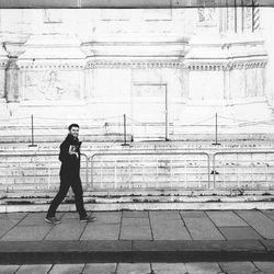 Full length of woman standing by railing