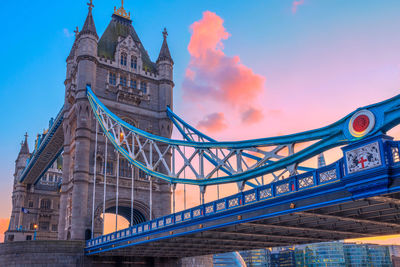 Low angle view of bridge against cloudy sky