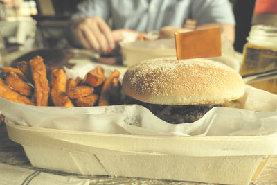 Close-up of food with person sitting in background 