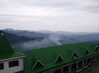 Scenic view of mountains against cloudy sky