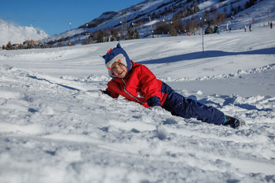 Portrait of woman skiing on snow covered mountain
