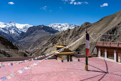 Rear view of woman walking on mountain against sky