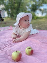 Portrait of cute baby girl sitting on table