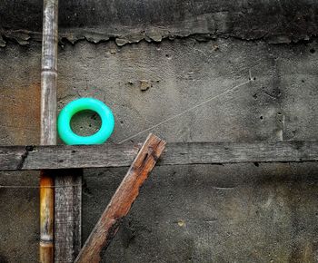 Wooden planks and rubber ring on concrete wall