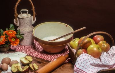 High angle view of apples with sugar in bowl on table