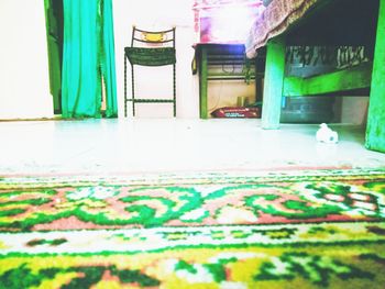 Empty chairs and tables against wall in building